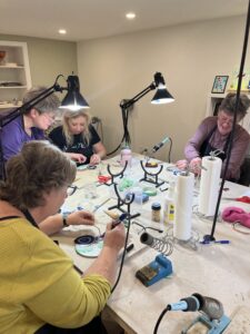 Beth Wallace leading a glass panel workshop